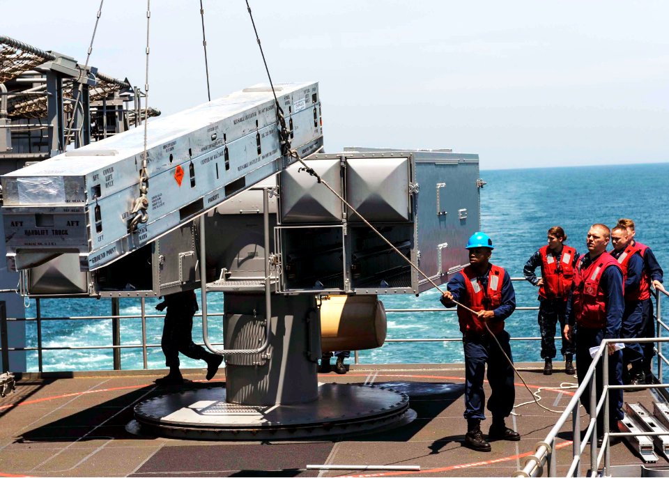 Sailors load a missile. (14273308593)