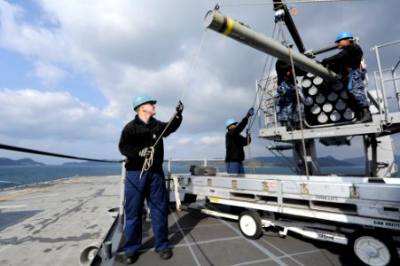Sailors remove a missile from a launcher. (8413081157)