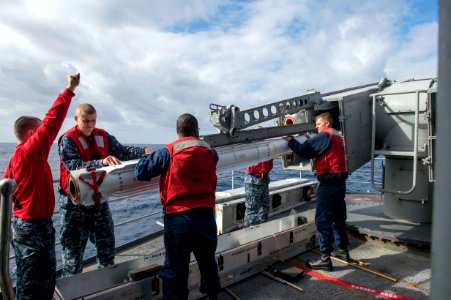 Sailors load a NATO Sea Sparrow missile at sea. (8516139060)
