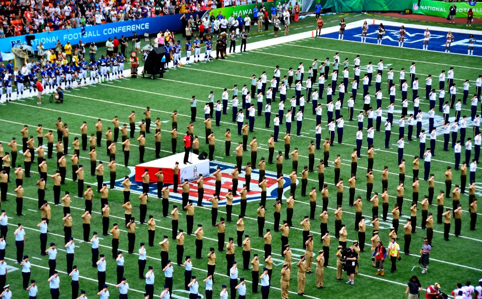 Sailors salute during the national anthem at the Pro Bowl. (8427156180)