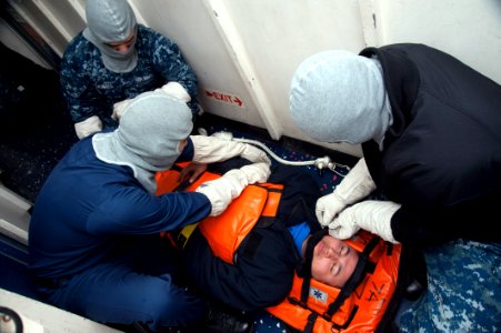 Sailors secure a simulated casualty to a stretcher. (8489344860)
