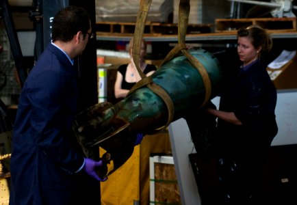 Sailors move a late 19th century Howell torpedo. (8939225922)