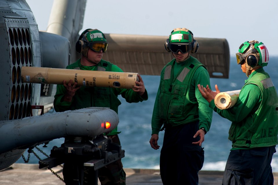 Sailors unload sonobous from an MH-60R. (8291330636)