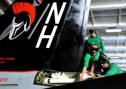 Sailors perform tail wing maintenance on F A-18E at sea. (8813982054)