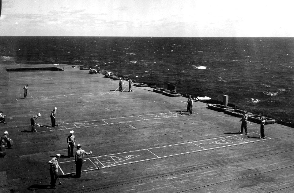 Sailors play shuffleboard on the flight deck of USS Fanshaw Bay (CVE-70), 25 October 1945 (80-G-364261)