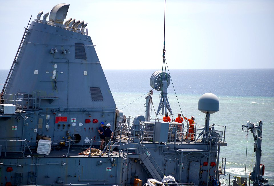 Sailors remove an antenna from USS Guardian. (8516137350)