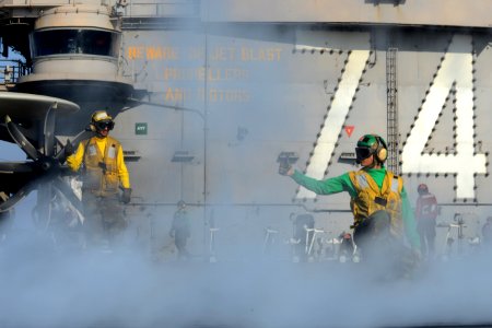 Sailors signal to launch an aircraft at sea. (8427151266)