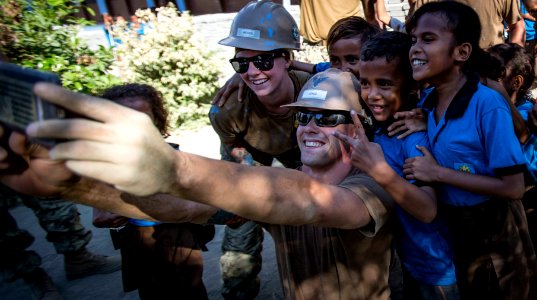 Sailors take a selfie with Timorese children at Aimutin School during Pacific Partnership 2016. (27095242644)