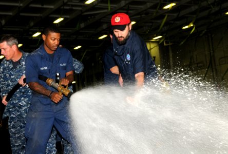 Sailors test AFF in the hangar bay. (8448064346)
