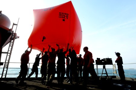 Sailors toss a floating target overboard. (8364956662)