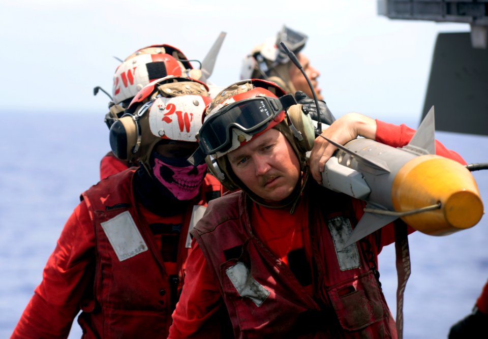 Sailors unload ordnance from an F-A-18E Super Hornet. (35479860381)