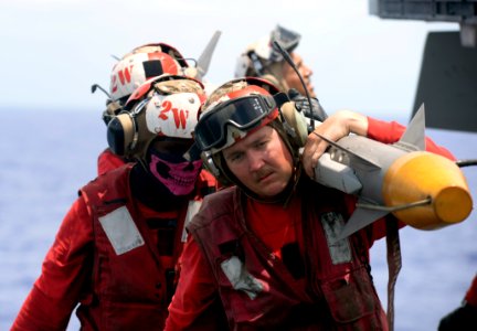 Sailors unload ordnance from an F-A-18E Super Hornet. (35479860381)