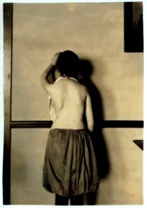 Same girl as no. 4665. Showing the slight deformity of the hip. Work which required constant standing would be bad, so persons with curvature tire quickly. Their feet also are usually weak LOC nclc.05146