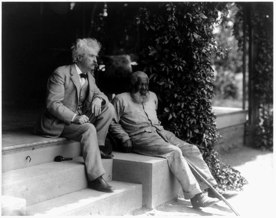 Samuel Clemens and John T. Lewis (an elderly African American man), both full length, seated on steps of porch LCCN2005680948