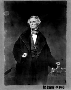 Samuel F.B. Morse, half-length portrait, posing with left hand on a telegraph apparatus, facing slightly left LCCN2001700118
