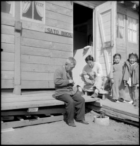 San Bruno, California. Father and son while away the hours carving small wooden animals for the chi . . . - NARA - 537905