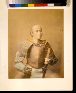 Samurai warrior, half-length studio portrait, facing front, wearing armor and holding a sword LCCN2009632867