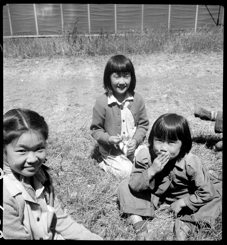 San Bruno, California. Young evacuees at this assembly center are happy to get their pictures taken. - NARA - 537909