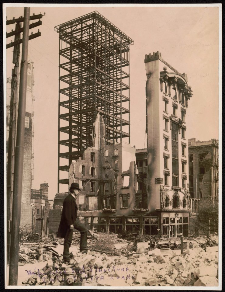 San Francisco disaster - earthquake and fire - man standing among rubble in foreground and unfinished steel structure of building and facade of another still intact in background LCCN2004680400