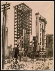 San Francisco disaster - earthquake and fire - man standing among rubble in foreground and unfinished steel structure of building and facade of another still intact in background LCCN2004680400