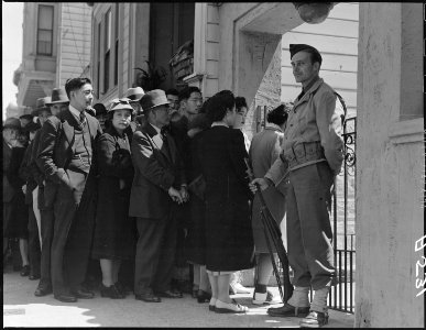 San Francisco, California. Japanese family heads and persons living alone, form a line outside Civi . . . - NARA - 536423 photo