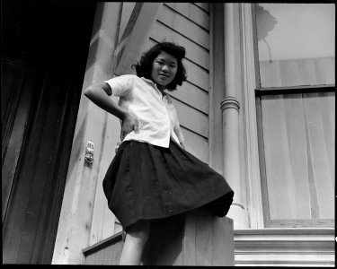 San Francisco, California. School girl pictured before her Bush Street home three weeks before evac . . . - NARA - 537469