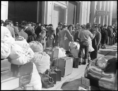 San Francisco, California. With baggage stacked, residents of Japanese ancestry await bus at Wartim . . . - NARA - 536065 photo