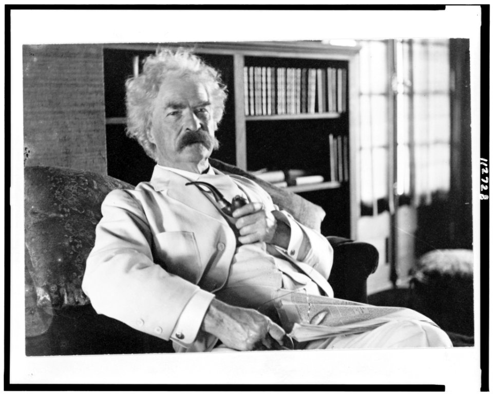 Samuel Langhorne Clemens, three-quarter length portrait, seated, facing slightly right, holding pipe LCCN95501005