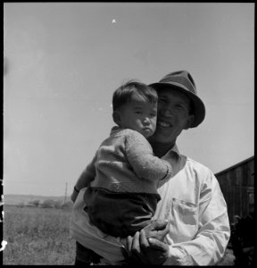 San Lorenzo, California. Farm laborer with his little son a few days prior to evacuation from this . . . - NARA - 537862