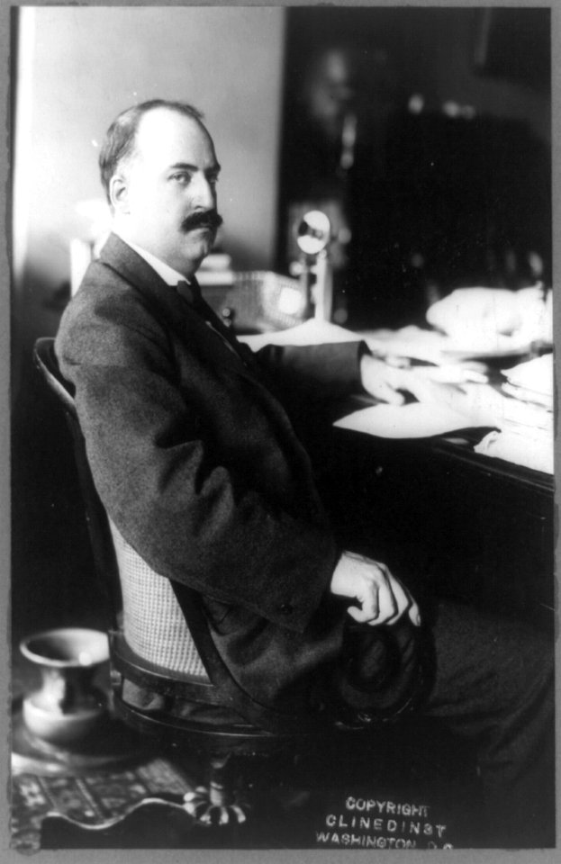 Samuel H. Adams, Asst. Secretary of the Interior, three-quarter length portrait, seated at desk, facing right LCCN89714537