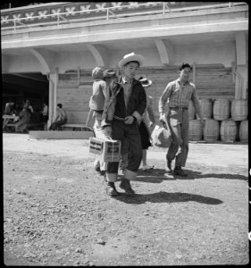 San Bruno, California. Family of Japanese ancestry arrives at assembly center at Tanforan Race Trac . . . - NARA - 537494 photo