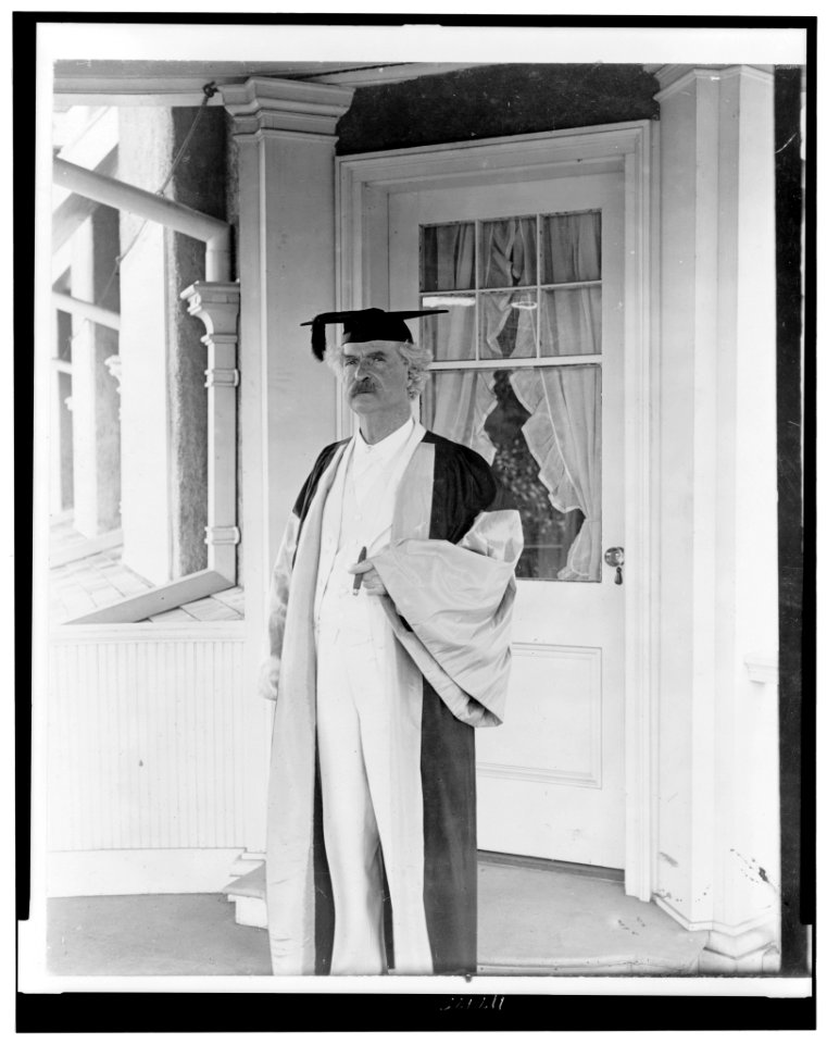 Samuel Langhorne Clemens, (Mark Twain), full-length portrait, standing, facing left, in academic cap and gown LCCN96523981