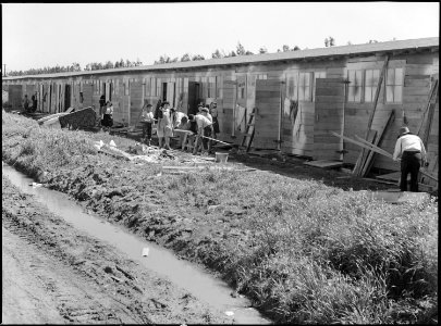 San Bruno, California. Barracks for family living quarters. Each door enters into a family unit of . . . - NARA - 537673