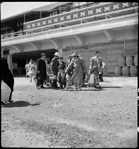 San Bruno, California. Families of Japanese ancestry arrive at assembly center at Tanforan Race Tra . . . - NARA - 537485 photo