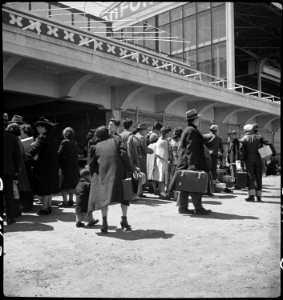 San Bruno, California. Families of Japanese ancestry arrive at assembly center at Tanforan Race Tra . . . - NARA - 537495 photo
