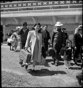 San Bruno, California. Family of Japanese ancestry arrives at assembly center at Tanforan Race trac . . . - NARA - 537482 photo