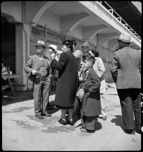 San Bruno, California. Family of Japanese ancestry arrives at assembly center at Tanforan Race Trac . . . - NARA - 537486 photo