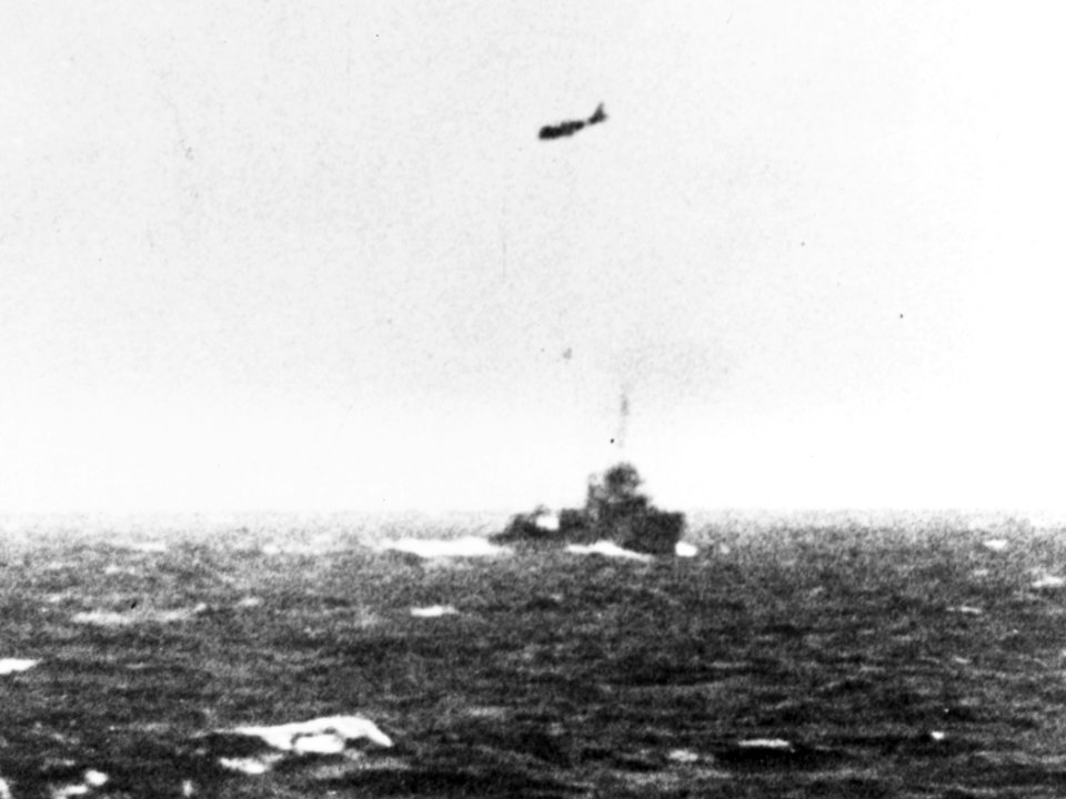 SBD Dauntless of VS-2 flies over destroyer during the Battle of the Coral Sea on 8 May 1942