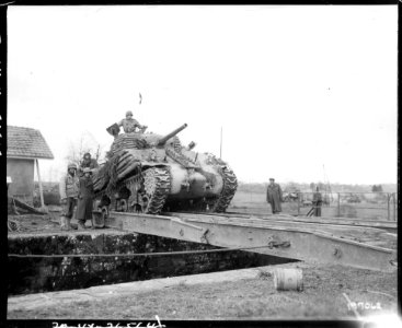 SC 177062 - A tank crosses a treadway bridge near Belfort, France, as the French drive to take this German strong point. November 20, 1944 photo