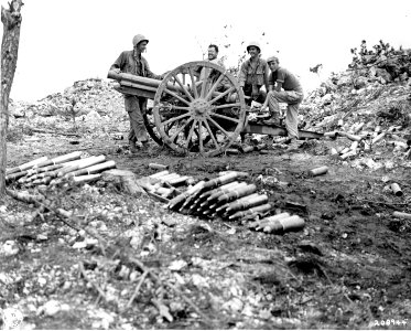 SC 208944 - Men of Co. B, 184th Inf. Regt., inspect a Jap 75-mm gun they captured on Okinawa. 29 May, 1945 photo