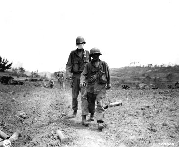 SC 207308 - Two wounded men make their way to a medical aid station on Okinawa photo