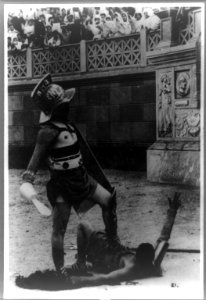 Scene from film Quo Vadis, showing a gladiator standing over a fallen Christian in arena LCCN93511523