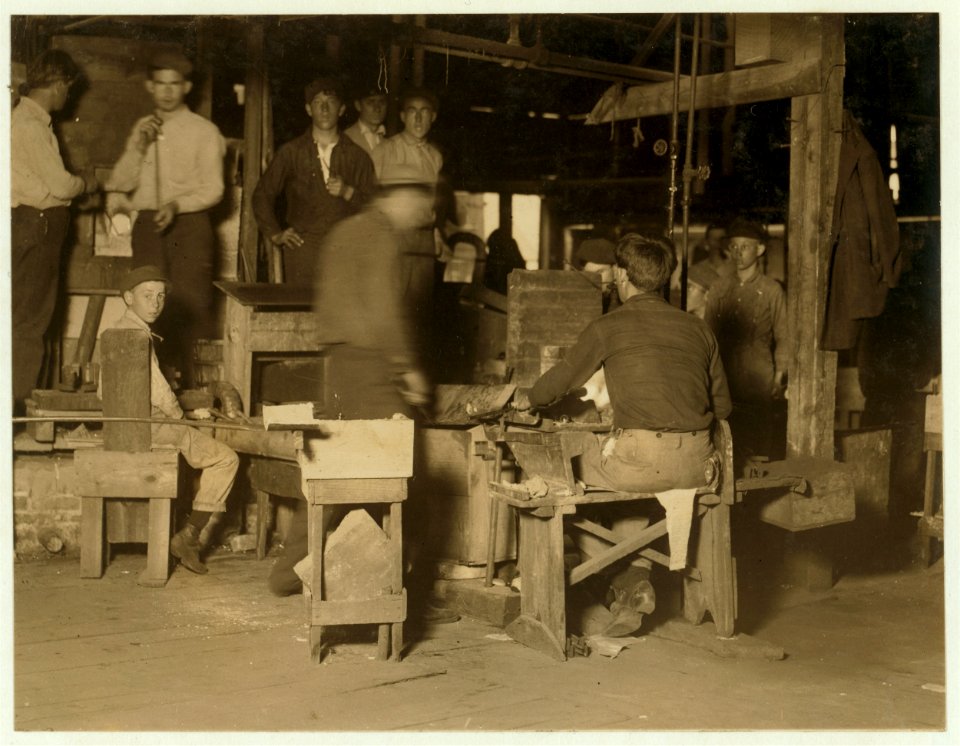 Scene in Cumberland Glass Works, Bridgeton, N.J. A young 'holding-mold-boy' on left of photo and young 'carrying-in-boy' in middle distance. LOC nclc.01214