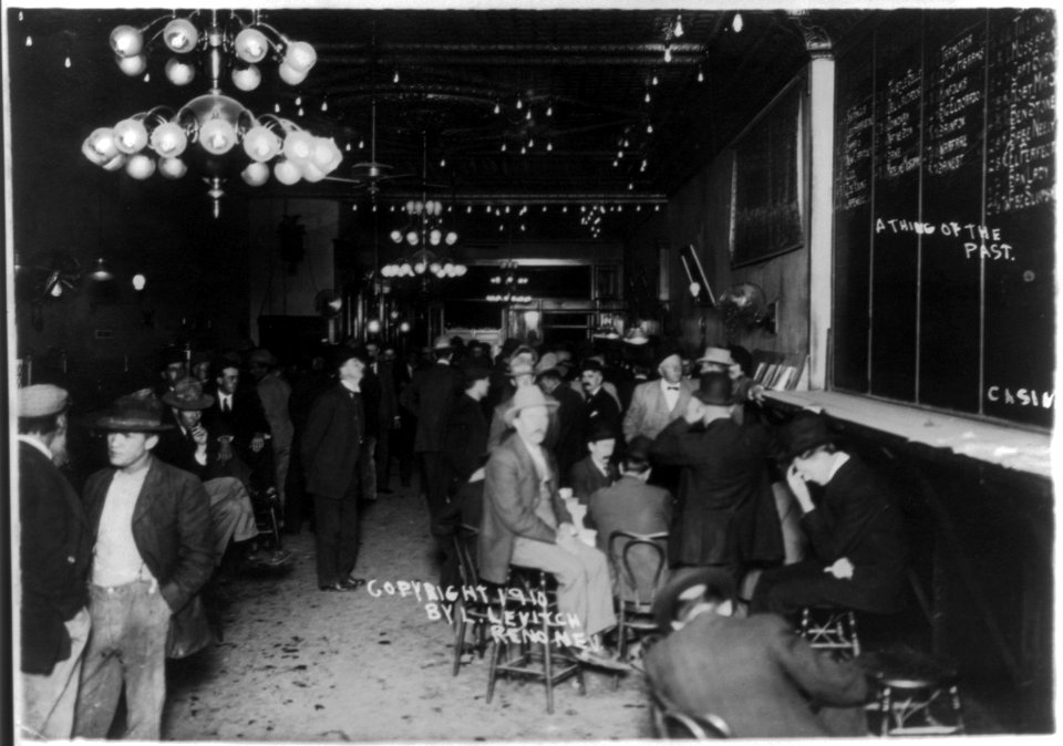 Scenes of open gambling in Reno, Nevada casinos- men beneath large blackboard with race results LCCN2003677178