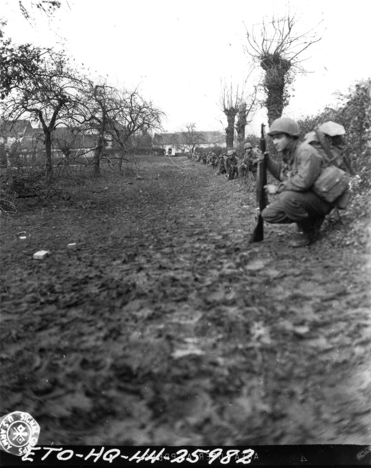 SC 197031 - Ninth Army infantrymen wait for the signal to move up in the initial attack on the town of Euchen, Germany. Co. A, 120th Inf. Regt., 30th Infantry Division. 16 November, 1944