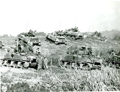 SC 206511 - During a respite in the hard fighting on Okinawa, these medium U.S. tanks bunch up closely on a rolling ridge, 1945 photo