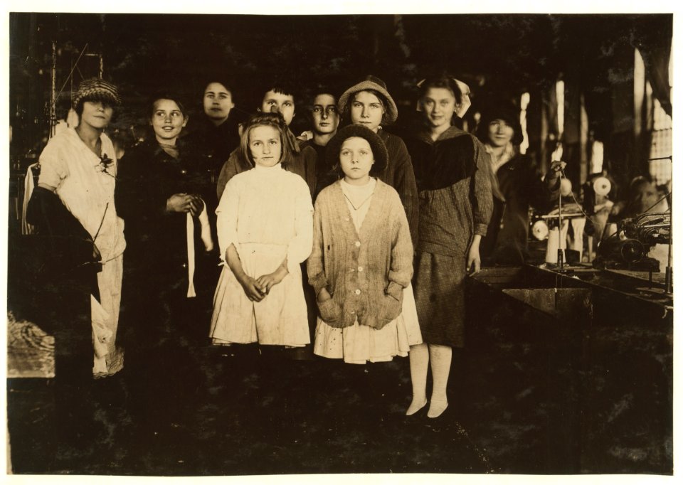 Scotland Neck Cotton Mill. Group showing some of the youngest workers taken in the mill at starting time. Tiniest girl, one apparently 8 or 9, I saw at work at her knitting machine perched LOC nclc.02952