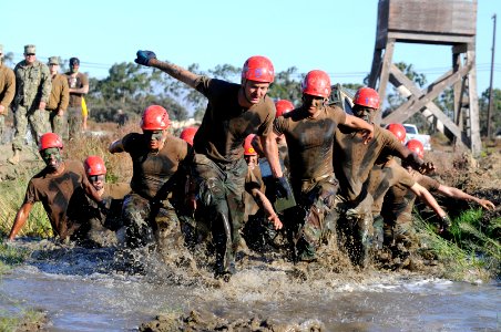 Seabees carry ammo cans through an obstacle. (8185234692)
