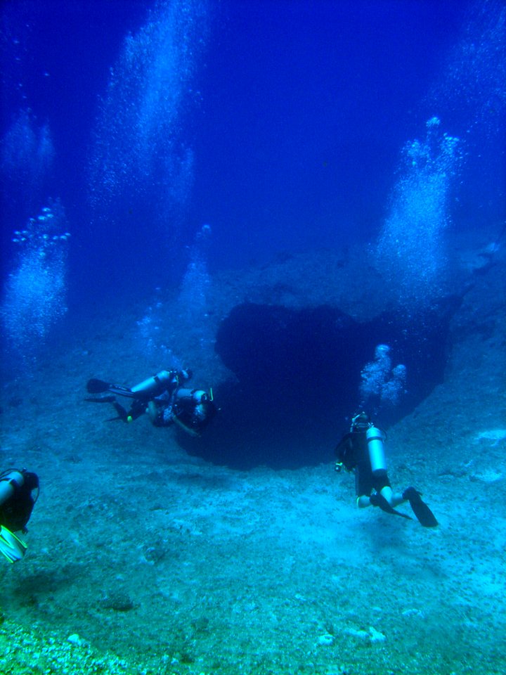 SCUBA divers approaching a sinkhole on a Guamanian reef (reef316936416)
