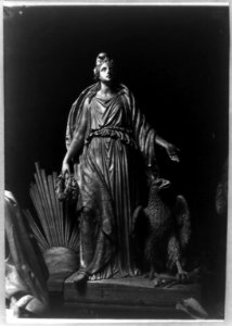 Sculpture of female figure draped in robe; eagle beside her, clutching arrows in one of its claws. Signature of J. Crawford on base LCCN2002717761